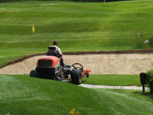 image of a greenkeeper maintaining a golf course