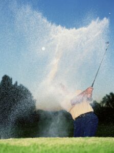 Image of man playing golf on golf ball injuries blog